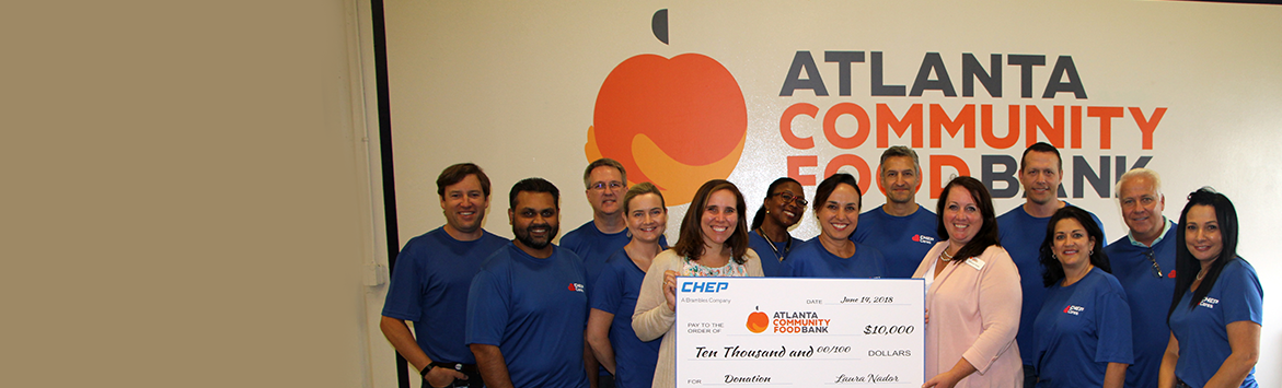 A banner image of a group photograph of members of the Atlanta Community Food Bank holding a large ten thousand dollar donation cheque.